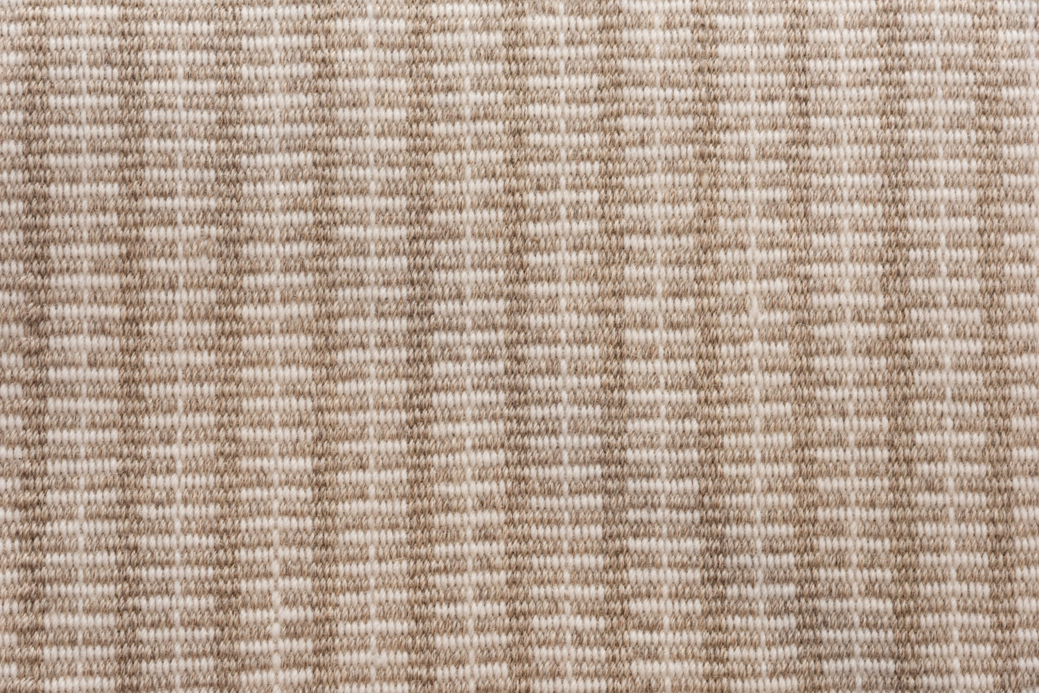Broadloom carpet in a ticking stripe in shades of warm tan and cream. 