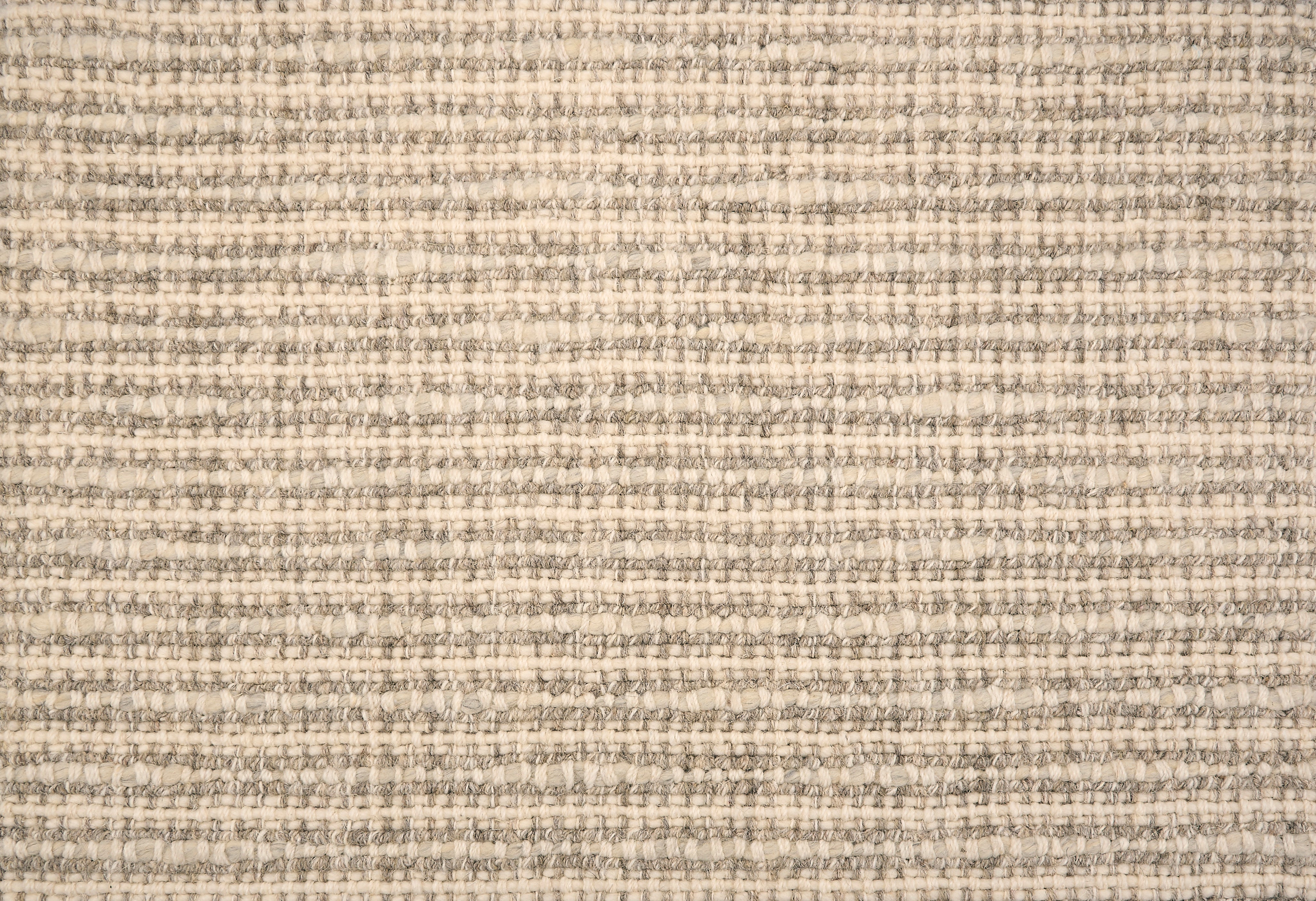 Broadloom carpet with textural weave in cream and grey. 