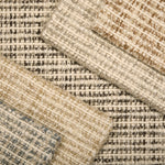 Array of Broadloom carpet samples with textural weave in neutral colors. 