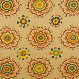 Detail of fabric in a floral paisley print in shades of blue, green and black on a cream field.