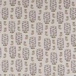 Detail of fabric in a small-scale floral print in shades of red, yellow and navy on a white field.