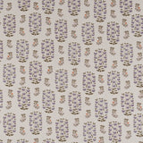 Detail of fabric in a small-scale floral print in shades of red, yellow and navy on a white field.
