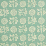 Detail of fabric in a repeating sunflower print in cream on a light turquoise field.
