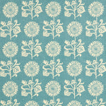 Detail of fabric in a repeating sunflower print in cream on a blue field.