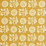 Detail of fabric in a repeating sunflower print in white on a mustard field.