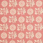 Detail of fabric in a repeating sunflower print in cream on a pink field.