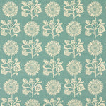 Detail of fabric in a repeating sunflower print in cream on a blue field.