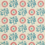 Detail of fabric in a repeating sunflower print in coral and blue on a cream field.