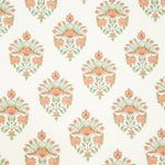 Detail of fabric in a floral paisley print in shades of green and coral on a white field.