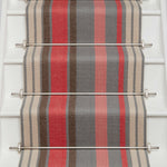 Striped flatweave runner in pink red grey and cream on white staircase