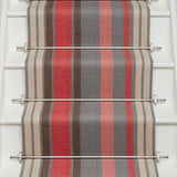 Striped flatweave runner in pink red grey and cream on white staircase