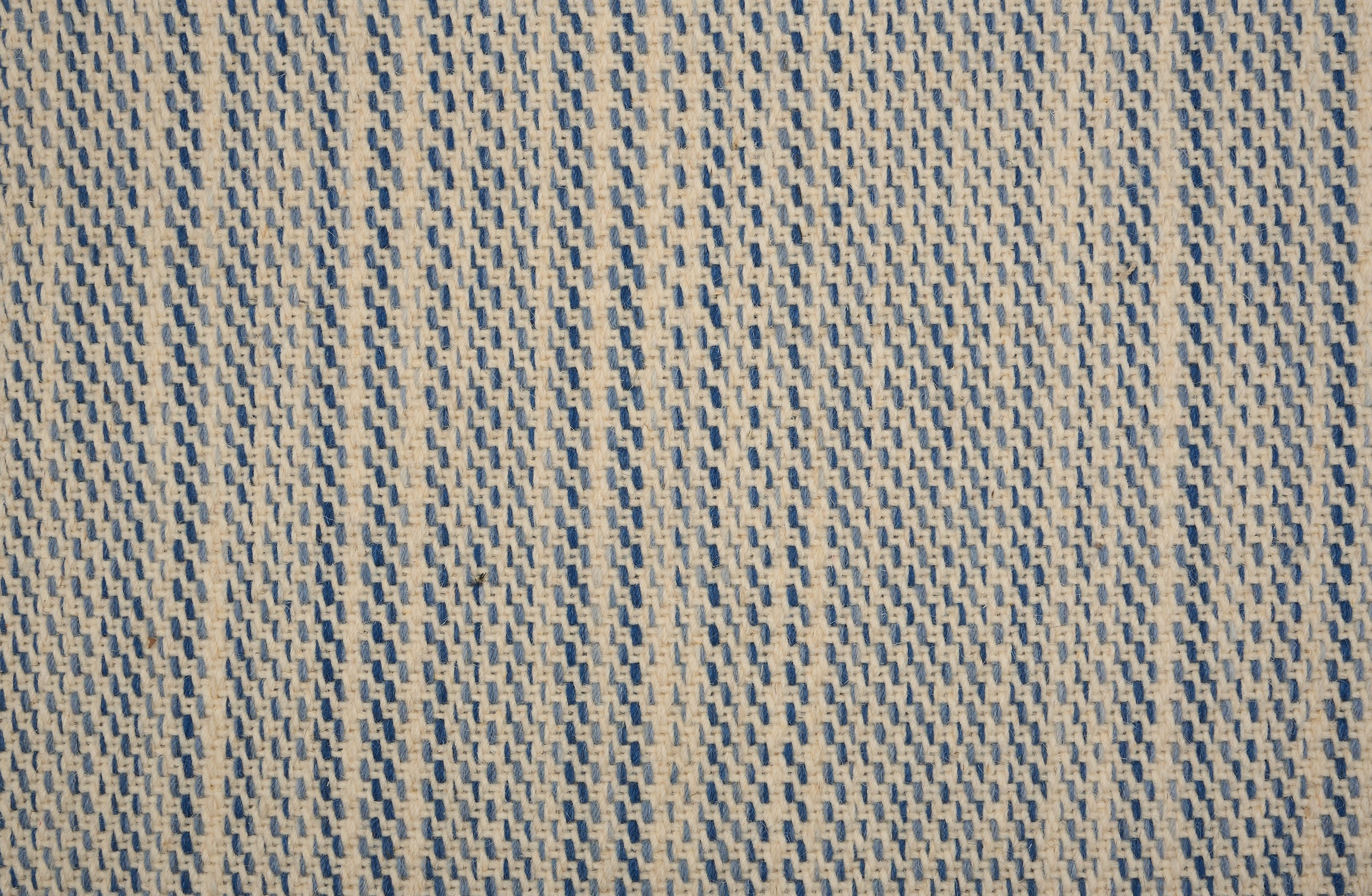 Broadloom carpet in a textural basketweave stripe in cream with stripes of blue.