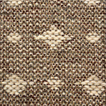 Close-up of a woven rug  with a diamond pattern in shades of cream on a brown field.