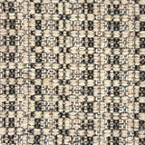 Close-up of a woven rug with textural pattern in shades of grey.