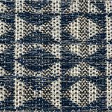 Close-up of a woven rug with geometric pattern in shades of blue.