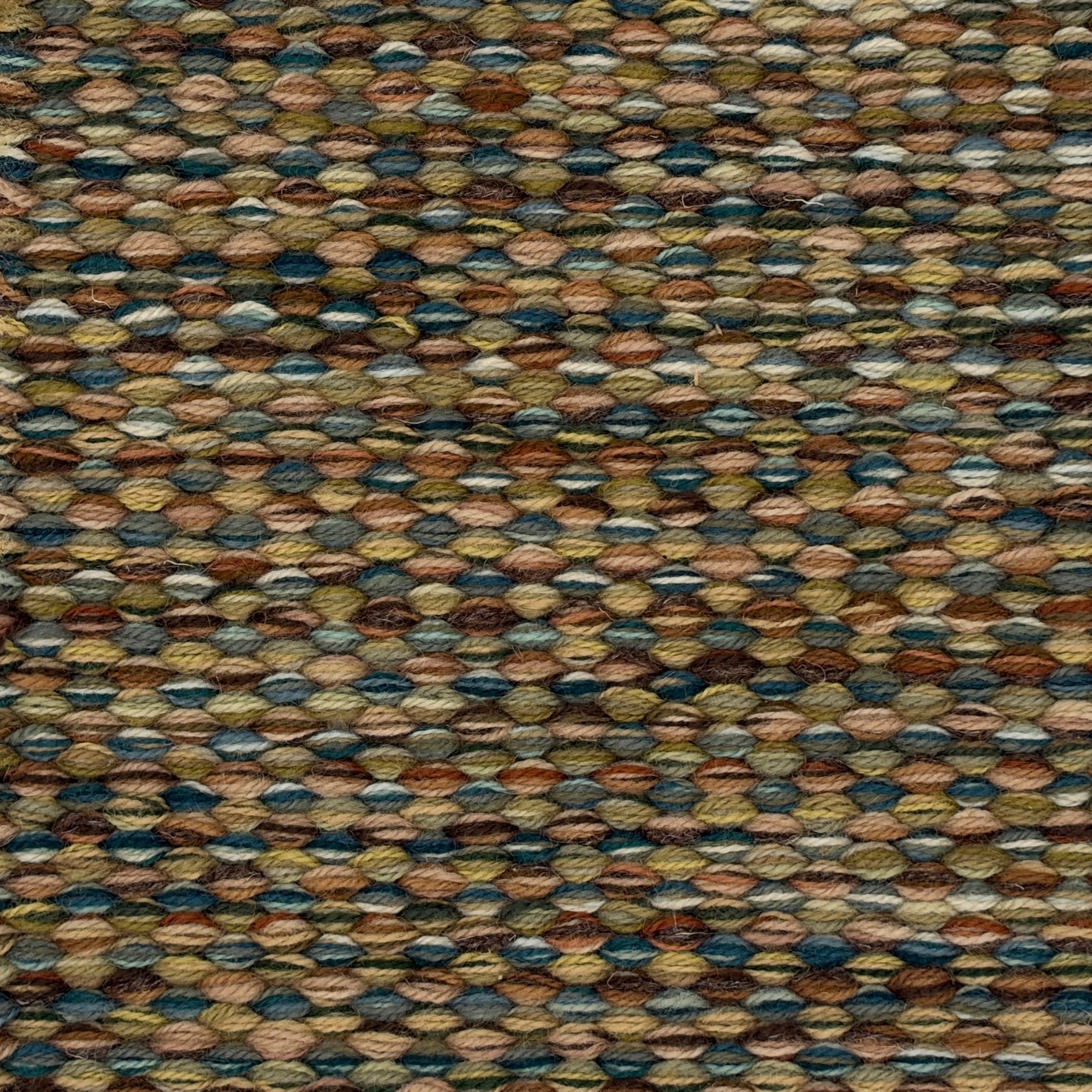 Handowoven rug in textural design in shades of green and brown.