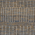 A close-up of a woven rug with a subtle stripe pattern in shades of light blue and tan. 