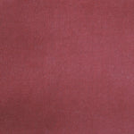 Detail of velvet fabric yardage in dusty red.