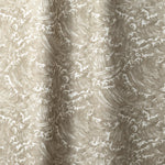 Playful wave print in white on a pale grey-green watercolor field.