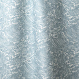 Playful wave print in white on a pastel blue watercolor field.