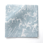 Fabric swatches in a playful wave print in white on a pastel blue watercolor field.
