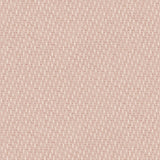 Detail of fabric in a small-scale dot and dash pattern in shades of cream and pink on a light pink field.
