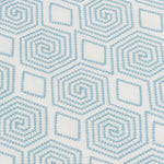 Detail of fabric with a playful embroidered geometric grid print in light blue on a white field.