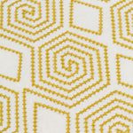 Detail of fabric with a playful embroidered geometric grid print in mustard on a white field.