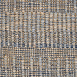 A close-up of a woven rug with a subtle stripe pattern in shades of light blue and tan. 