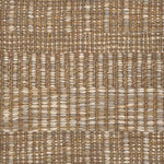 A close-up of a woven rug with a subtle stripe pattern in shades of taupe and tan. 