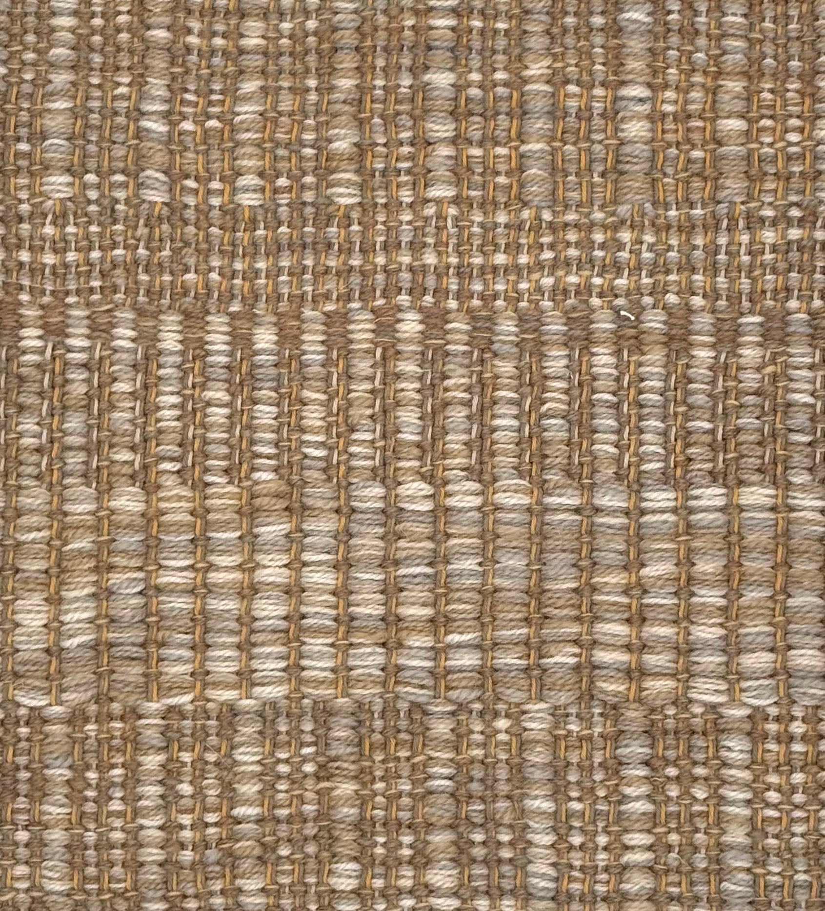 A close-up of a woven rug with a subtle stripe pattern in shades of taupe and tan. 