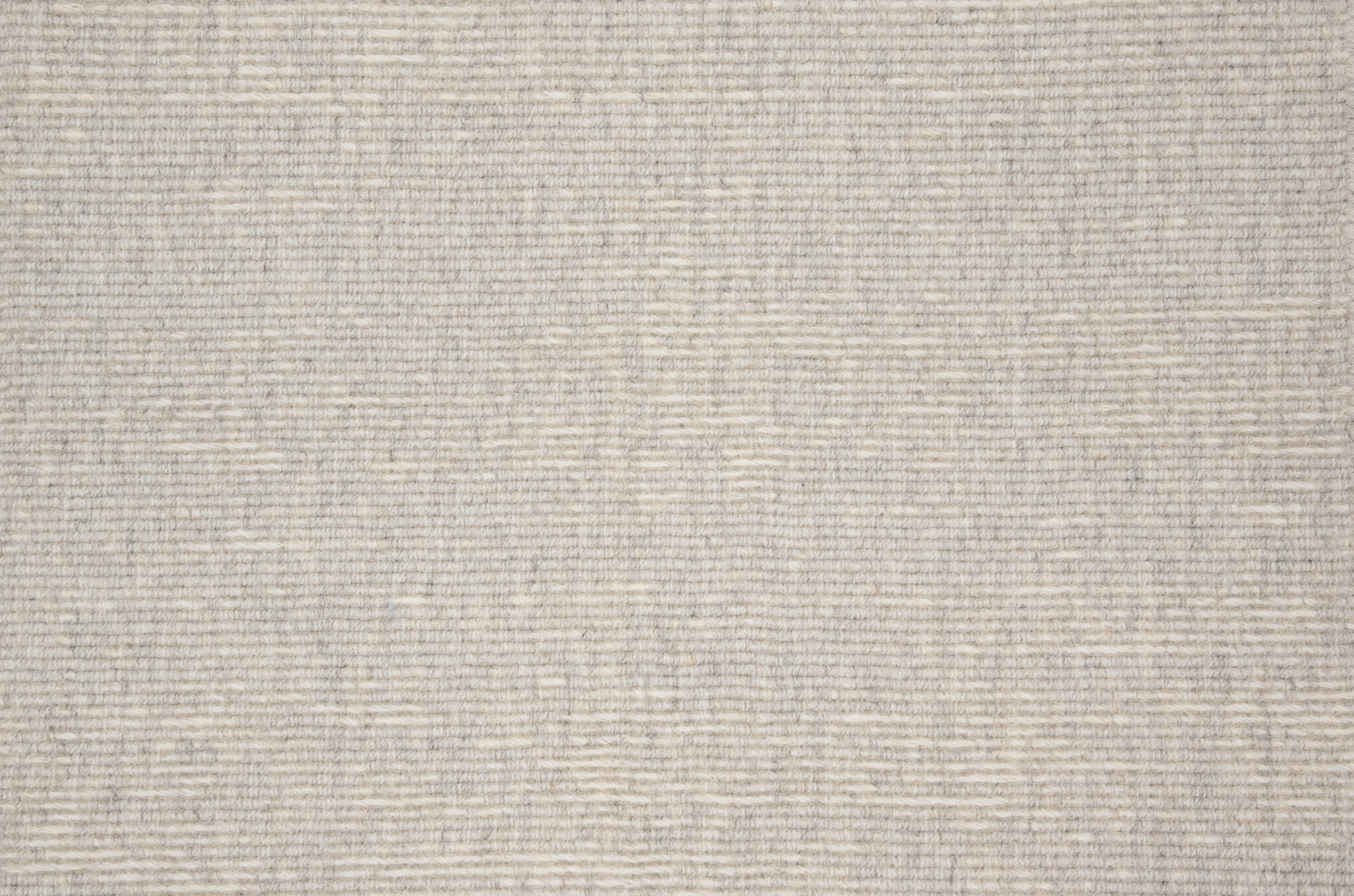 Broadloom carpet with ribbed stripe in light grey. 