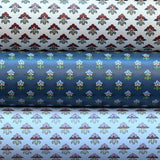 Three wallpaper rolls with dainy floral patterns. 