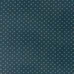 printed linen fabric in a clustered dot pattern in cream on an indigo field.
