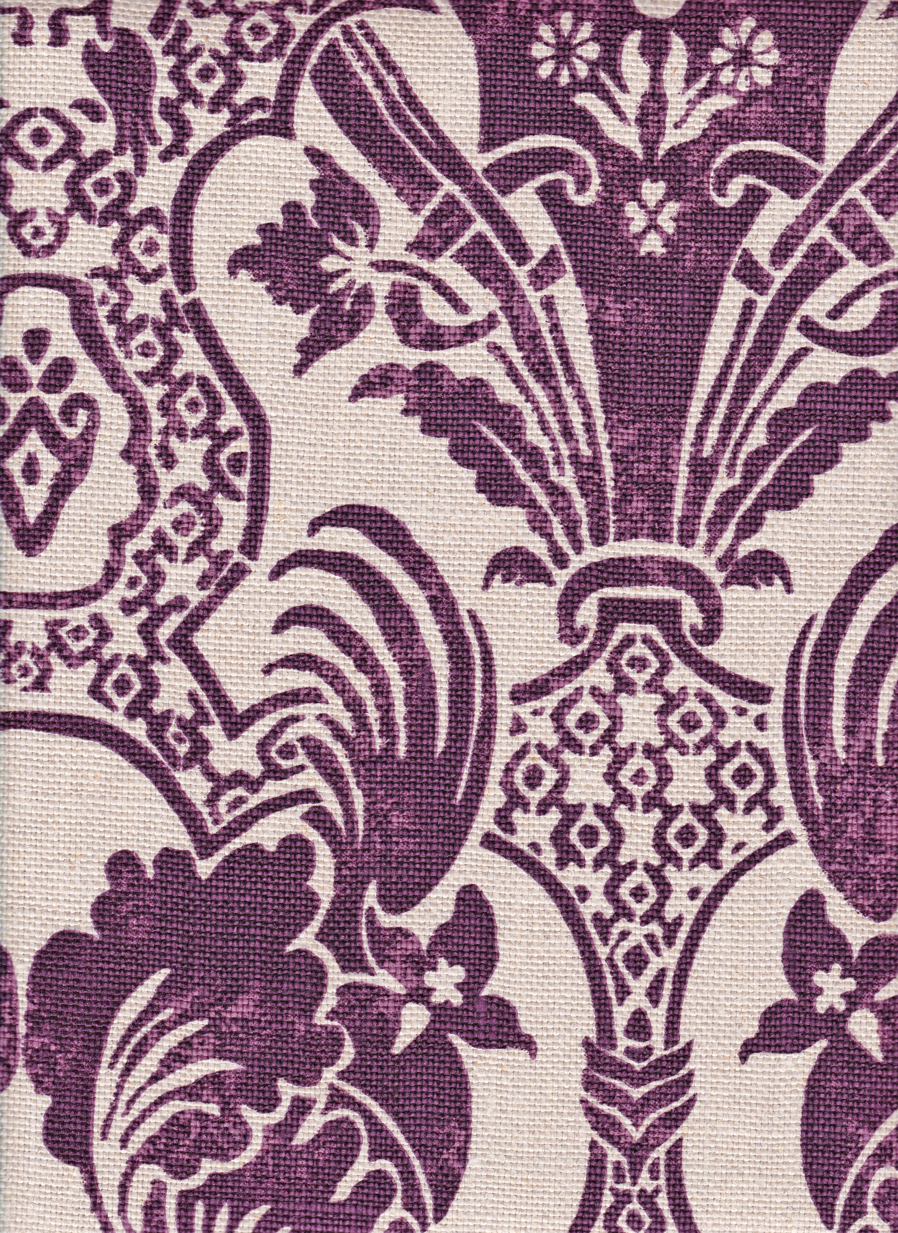 Detail of fabric in a damask vase print in purple on a cream field.