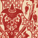 Detail of wallpaper in a damask vase print in red on a cream field.