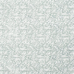 Detail of fabric in a dense paisley print in white on a gray-blue field.