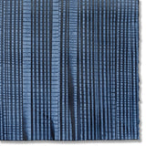 Detail of a hand-painted wallpaper swatch with an irregular grid pattern in charcoal on a navy field.