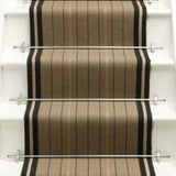 Striped flatweave runner in tan and black on white staircase