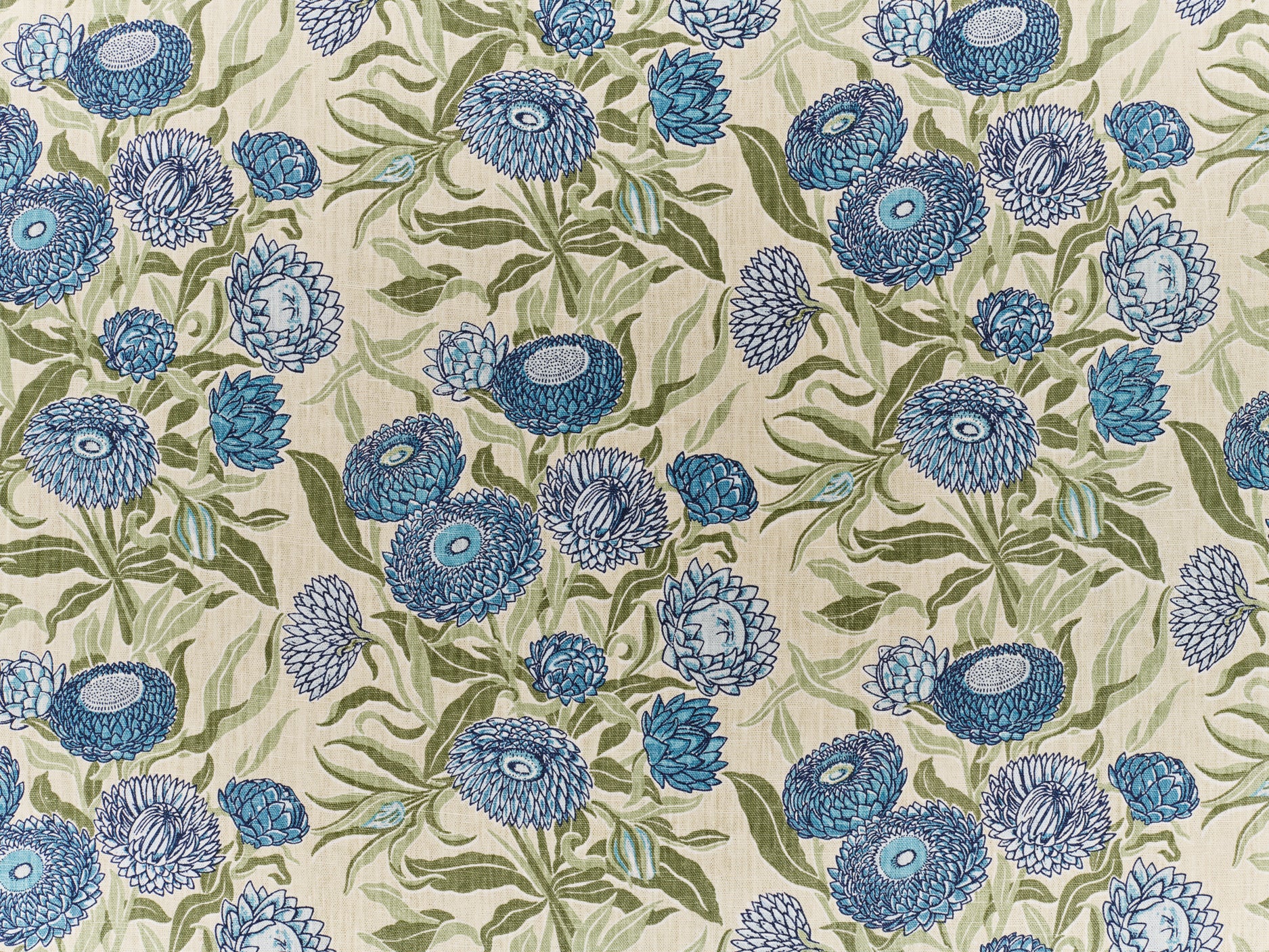 Printed linen in a hand drawn daisy design in shades of blue with green leaves on a pale cream field.