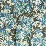 Draped fabric in a wildflower print in white, and green atop a textured brown and blue field.