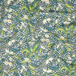 Draped fabric in a dense floral print in yellow, green and navy on a cream field.