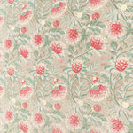 Printed fabric in a lush floral botanical design in red, pink, yellow green and turquoise on a tan field. 