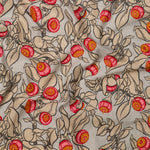 Draped fabric in a leaf and bud print in shades of tan, pink and yellow on a light gray field.