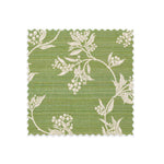 Fabric swatch on white of performance fabric with a scrolling floral design in green. 