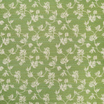 Performance fabric with a scrolling floral design in green. 