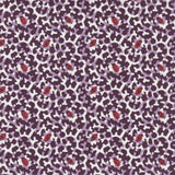 Detail of fabric in a playful irregular botanical print in red and purple on a white field.
