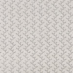 Panel of embroidered fabric in a linear geometric print in white and black on a cream field.