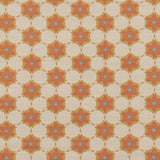 Woven fabric in a floral lattice print in orange, red and blue on a tan field.