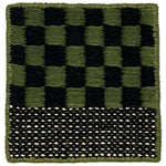 Flatweave rug sample in a green and black checkerboard with striped border.